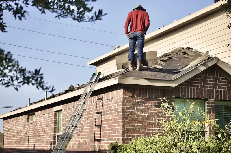 Professional roofer working on a residential roof in Lynnhurst